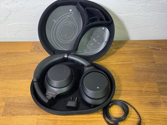 Pair Of Wireless Sony Head Phones In Carrying Case With Charging Cables