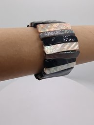 Stretch Bracelet Featuring Alternating Panels Of Abalone Shell And Mother Of Pearl.