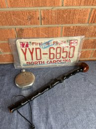 License Plate, Flask And Beating Stick