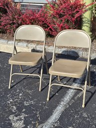 Pair Of Beige Metal Folding Chairs