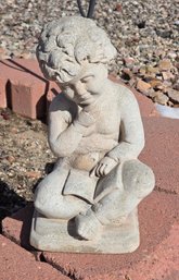 Concrete Garden Statue Depicting A Young Boy Sitting And Reading A Book