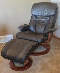 Vegan Leather Recliner Chair With An Accompanying Ottoman On A Wooden Swivel Base