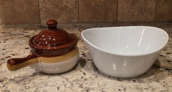 French Onion Soup Crock With A Lid, Alongside A Modern White, Asymmetric Ceramic Bowl