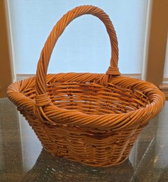 Handwoven Wicker Basket Featuring A Braided Rim And A Sturdy Handle