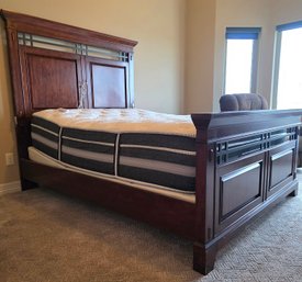 Features A Traditional Style Wooden Bed Frame With A High Panel Headboard And Footboard