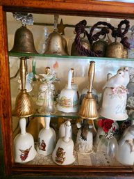 All This Collectable Unique Bells  On The Left Part Of The Cabinet Lot 160