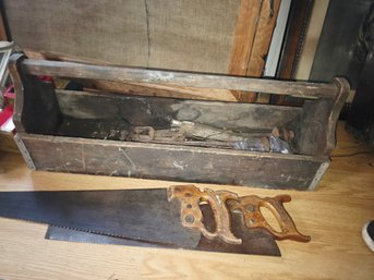 Two Hand Saws And A Large Wooden Tool Box With Old Tools