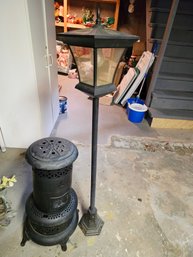 Outdoor Black Solar-powered Lamppost And A Vintage-style Portable Round-base Metal Heater