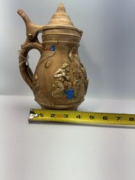 Antique Lidded Ceramic Beer Stein Featuring An Embossed Or Raised-relief Tavern