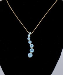 10k Yellow Gold Blue Topaz Wave Pendant Necklace