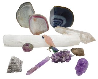 Collection Of Various Minerals And Crystals, Including Agate Geodes, Amethyst Specimens, And A Selenite Wand.