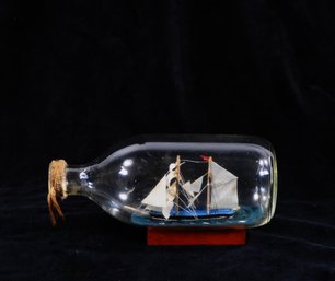 Vintage Handcrafted Ship In A Bottle On Wooden Stand