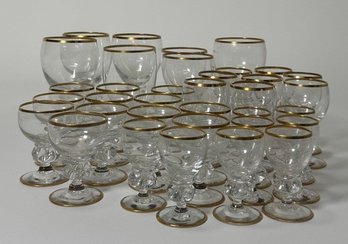Set Of Gold-Rimmed Stemmed And Larger Glasses