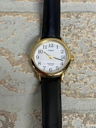 Timex Indiglo WR 30M Quartz Wristwatch  Gold Tone Case, Black Leather Band  Date Window