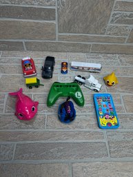 Mixed Toy Lot W/ Vehicles, Hot Wheels, Baby Shark, Nintendo Switch Grip & More