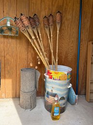 Tiki Torches, And Two Metal Bins With Lids