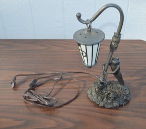 Froggy Hangs Out Under The Lamp Light Trying To Croak Out A Tune