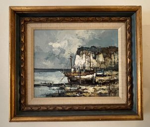 FRAMED SIGNED ART PRINT DEPICTING BOATS DOCKED NEAR A ROCKY CLIFFSIDE SEASCAPE SCENE