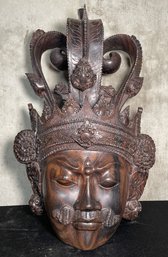 Ornate Wall Hanging Appears To Be A Carved Wooden Mask Of An Asian Deity
