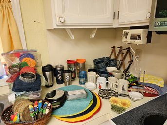 R3 Assorted Kitchen Items To Include, Electric Can Opener, A Variety Of Mugs, Placemats And Other Items