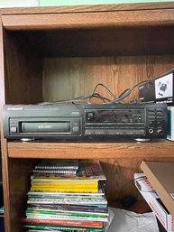 Mixed Media Lot Including CDs, Books, DVD Players, Magazines, A Discman, And A Fan