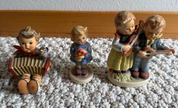 R3 Three Hummel Figurines, Happy Days And Two Without Titles On The Figurine