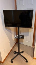 BR 2 TV Lot To Include Flatscreen, Rolling Stand, And Accessories