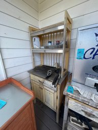 Outdoor Counter And Shelving Unit With Various Wood Chip And Grilling  Utensils
