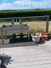 Wood Raised Bed Planter, Five Plants In Mostly Plastic Pots, And Mat