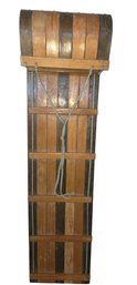 Vintage Wooden Toboggan With Alternating Light And Dark Wood Slats, Horizontal Wooden Cross Braces, A Curved F