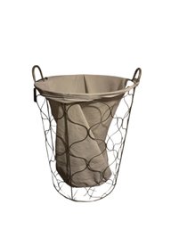 Wire Laundry Basket With A White Fabric Liner.