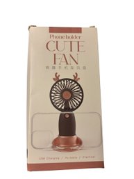 Portable Mini Cooling Fan That Features A Built-in Mobile Phone Holder.