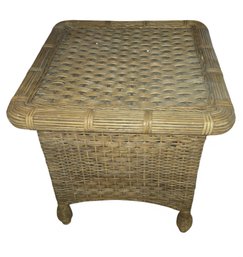 Vintage 1980s Boho Chic Rattan End Table With A Unique Woven Design And Decorative Feet.