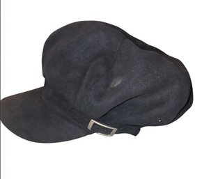 Black Newsboy Or Baker Boy Cap With A Buckle Accent.
