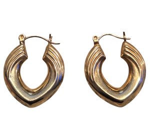 A Pair Of Vintage 14k Yellow Gold Textured Oval Hoop Earrings With A Hinged Back Closure.