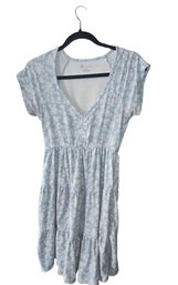 Size Medium Light Blue, White Floral, Tiered Mini Dress With A V-neck And Cap Sleeves.