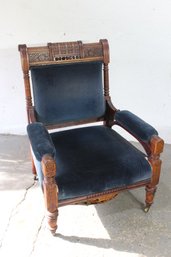 Antique Upholstered Carved Armchair With Casters