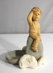 Handcrafted Clay Figurine Of A Child On Rock With Bowl Accent, 11' Tall