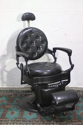 Vintage Barber Chair With Black Tufted Leather And Ornate Cast Iron Base