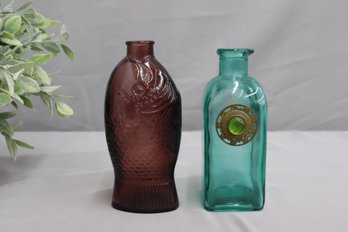 A Pair Of Colored Glass Decorated And Figural Bottles