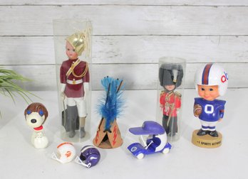 Vintage Mixed Toy Lot  Snoopy Bank, Football Bobblehead, British Guard Dolls, Mini Helmets & More
