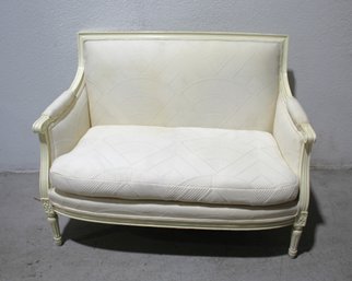 Vintage French Louis XVI Style Settee With Carved Details And Cream Upholstery