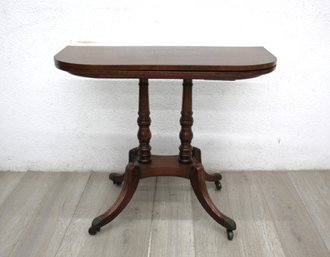 Antique Leather-Top Mahogany Table With Turned Legs And Casters