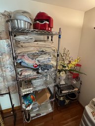 Two Racks Full Of Home Goods Linens Glassware Etc Racks Made By NSF Co.
