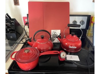 Two Red Le Creuset Teapots and Lidded Saucepan
