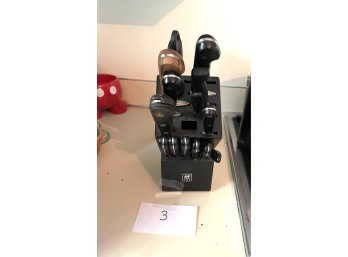 Group of Kitchen Knives in Plastic Knife Block