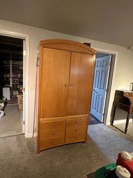 Light Brown Wood Armoire With Double Doors And Four Lower Drawers