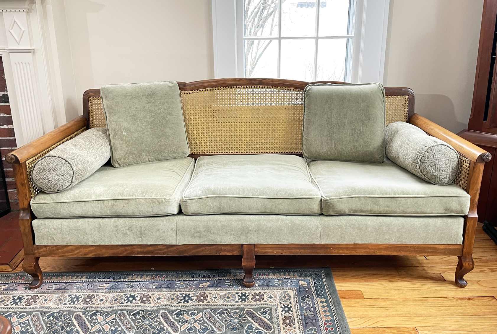 A Late 19th Century Carved Mahogany Cane Back Sofa With Carved
