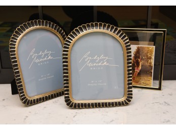 Pair Of Badgley Mischka Frames With A Black And Gold Frame