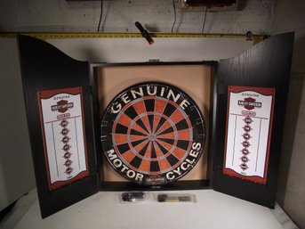 VINTAGE HARLEY DAVISON DART BOARD WITH CABINET AND DARTS.